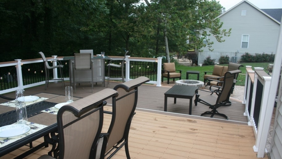 two-level deck with dining table and other nearby seating.