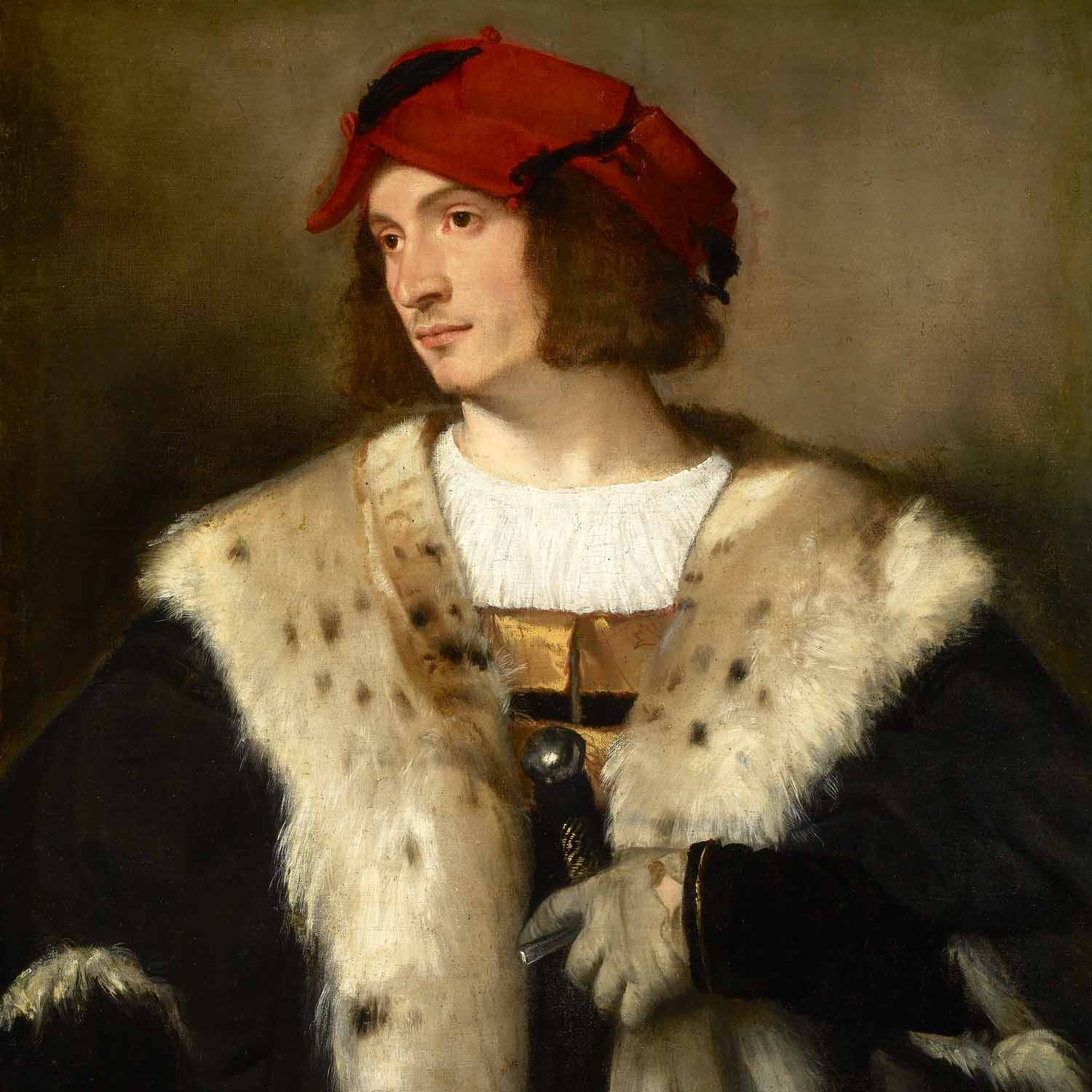 man wearing a red cap and a black fur-trimmed cloak