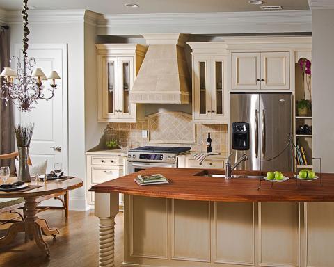 Kitchen with wooden countertop and stainless steel refrigerator