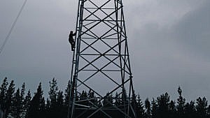 Champagne ascends the 30-m ladder to his lookout perch (Photograph by Amber Bracken)