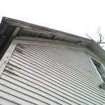 Rotten soffit and old roofing on shed