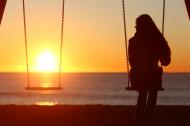 Woman alone on a swing.