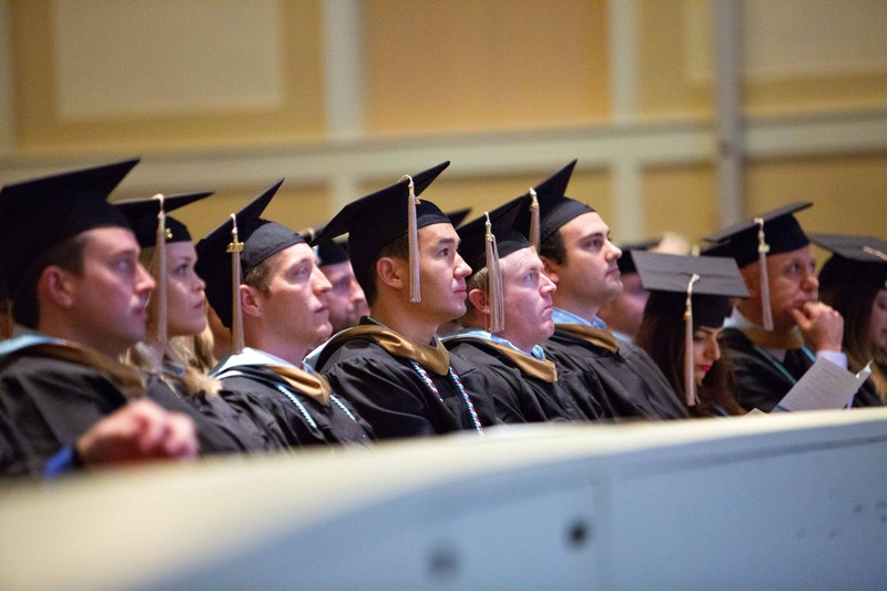 College graduates look on as their graduation ceremony commences