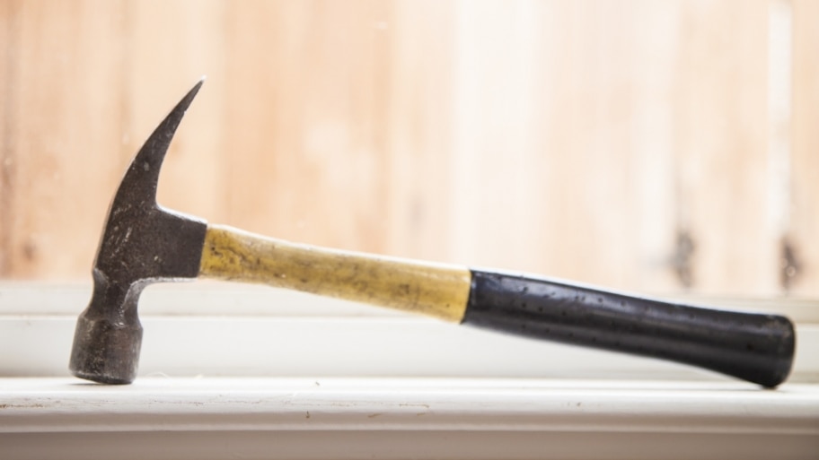 contractor&#039;s claw hammer sitting in window sill during remodeling project