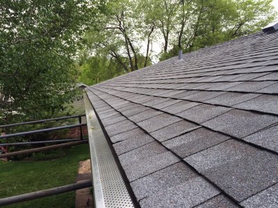 new asphalt shingle roof and gutters with gutter guards