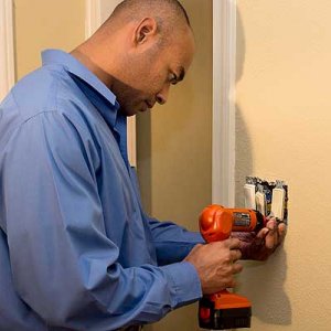 electrician working on light switch