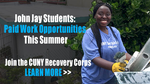 CUNY Corps student on a ladder doing work on the roof