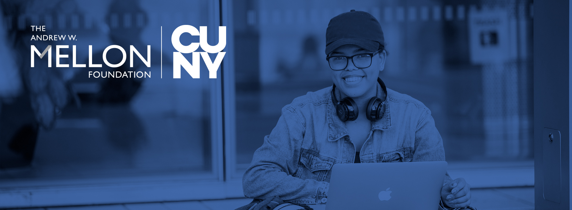 female John Jay College student outdoors using a laptop computer