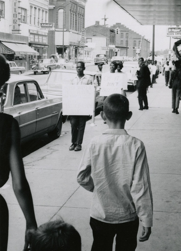 1963: Two young men, one Black and one White, face each other on Main Street, Farmville, Va. 