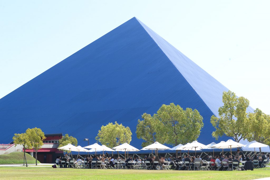 Outdoor umbrella pincic lunch on the lawn next to Walter Pyramid