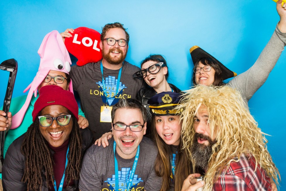 WordCamp Long Beach Organizers posing with funny props in photoshoot