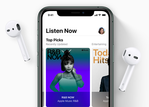 iPhone with AirPods on either side, music artwork on screen.