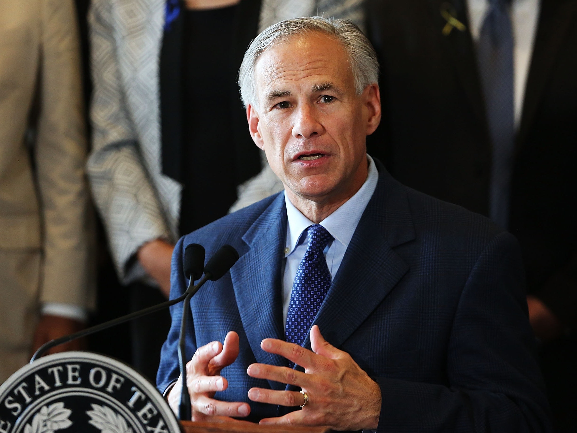 Image may contain Greg Abbott Tie Accessories Accessory Suit Coat Clothing Overcoat Apparel Human and Person