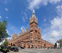 red stone building with tall clock tower in corner