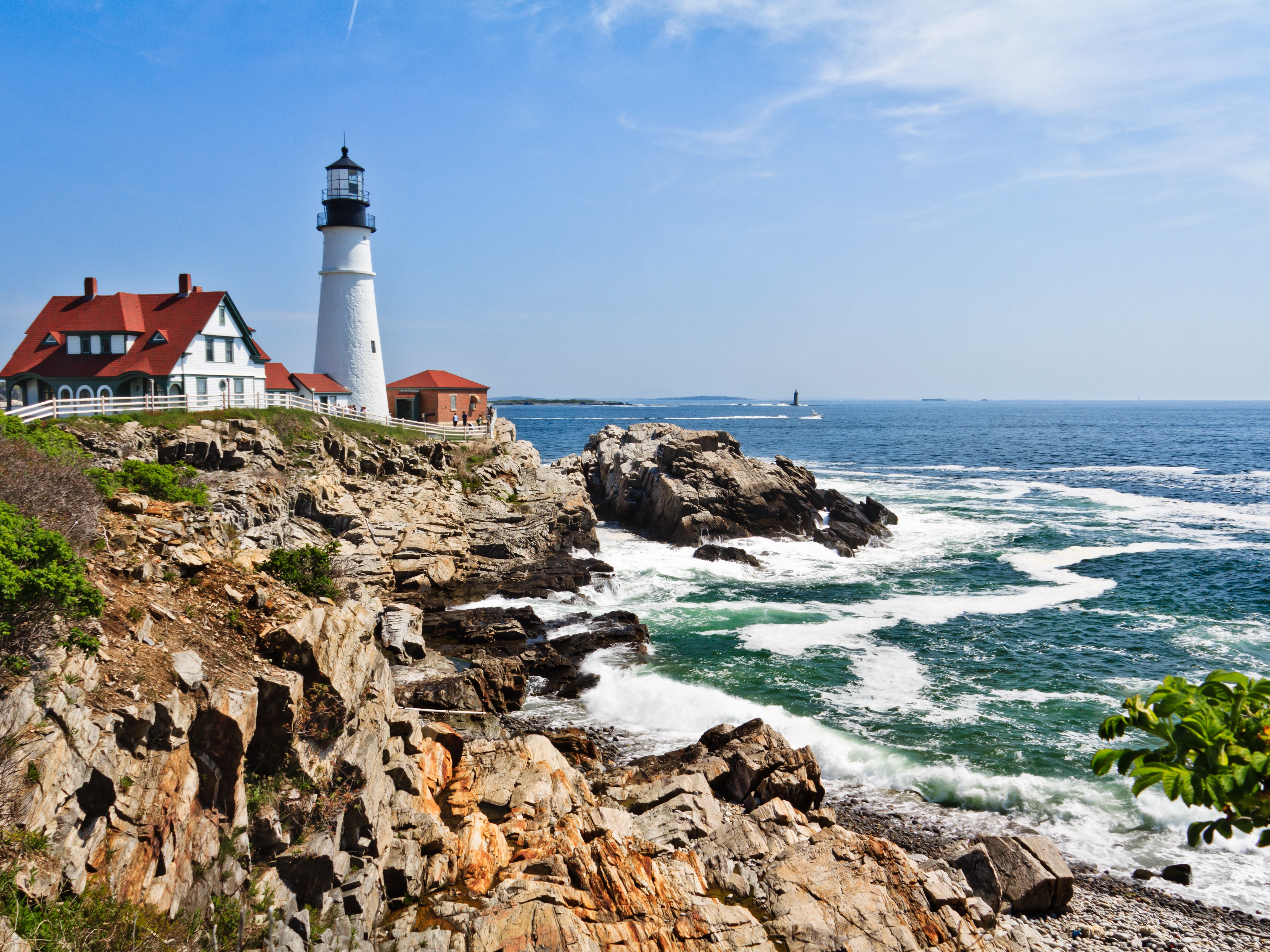 UNVERIFIED CONTENT Waves rolling in at Portland Head Lighthouse at Cape Elizabeth Maine on a warm sunny spring morning.