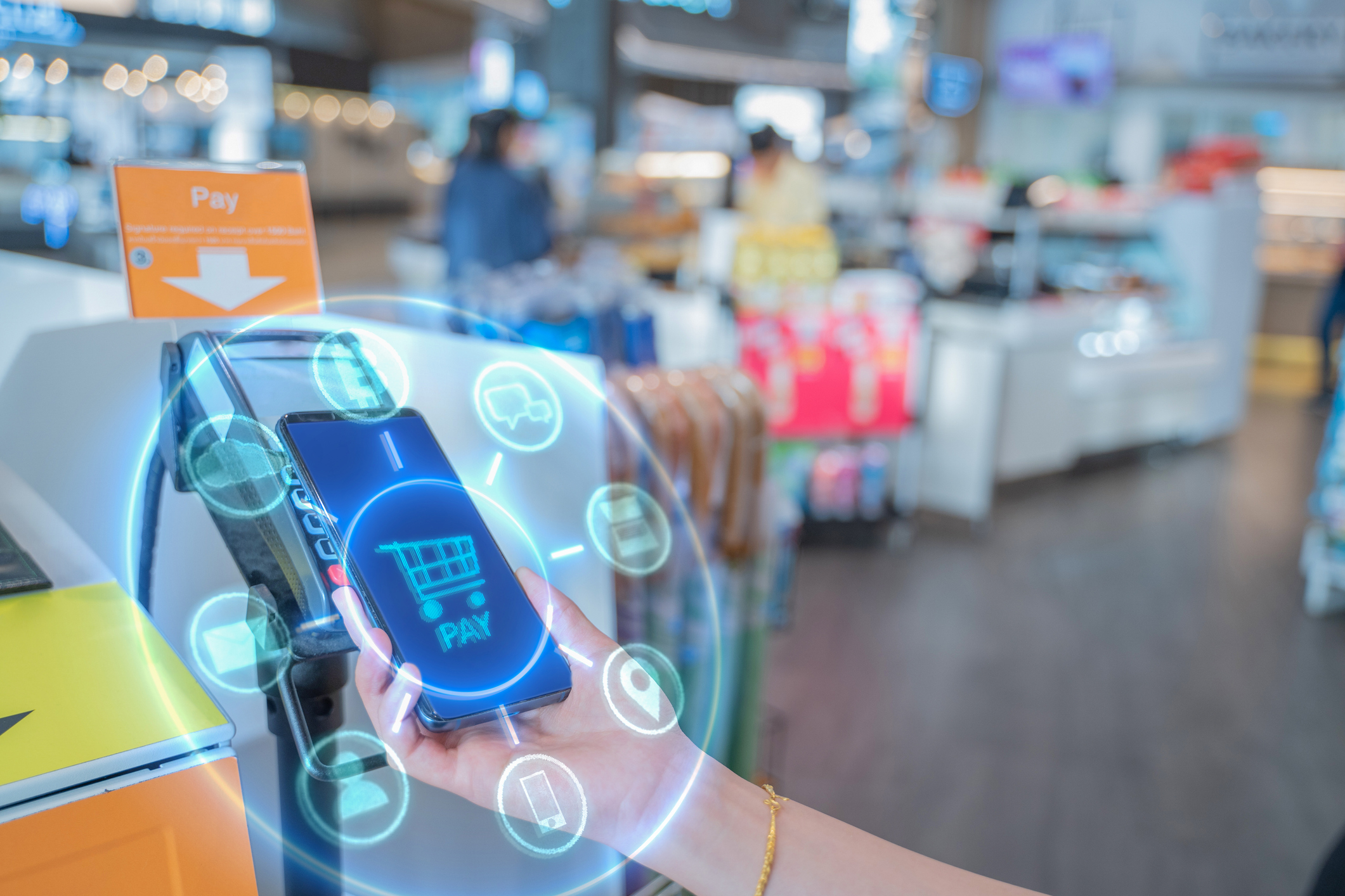 A hand holding a phone while doing mobile payment