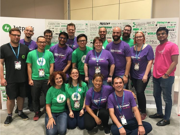 WooCommerce and Jetpack teams posing at an event booth