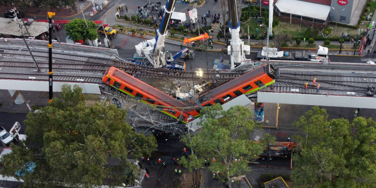 Image: A general view of the damage caused after a railway overpass and train collapsed onto a road in Mexico City