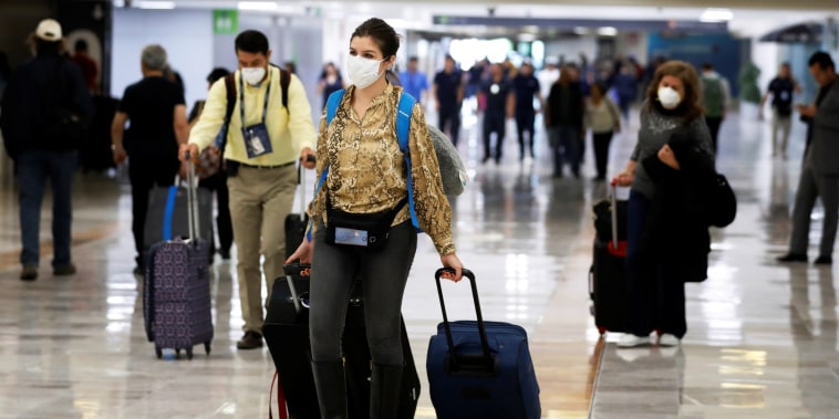 People walk in Benito Juarez International Airport in Mexico City on Feb. 28, 2020.