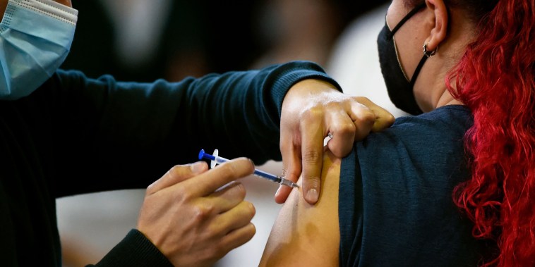 A woman receives her first dose of the AstraZeneca Covid-19 vaccination in Mexico City on July 13, 2021.