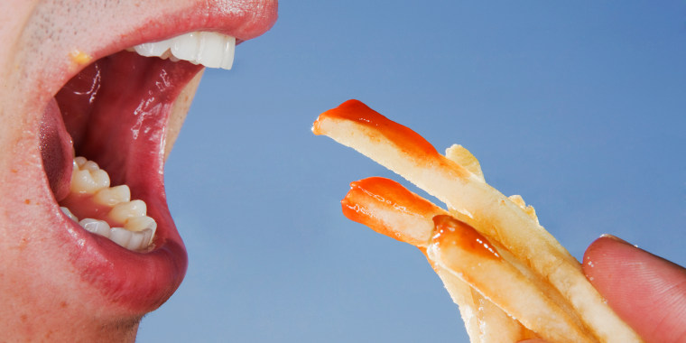 Close-up of someone eating french fries