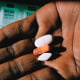 Image; An AIDS patient shows his medication in a 2004 photo.