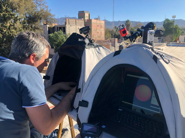 Man checking astronomical equipment