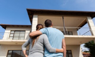 young couple looking at their new house