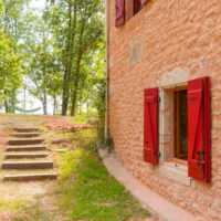 Country home with outdoor steps and hammock