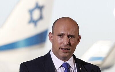 Prime Minister Naftali Bennett delivers televised remarks at Ben Gurion Airport, on June 22, 2021. (Jack Guez/AFP)