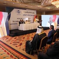 Iraqis listen to Sahr al-Ta'i at the conference of peace and reclamation organized by US think-tank Center for Peace Communications in Erbil, the capital of northern Iraq's Kurdistan autonomous region, on September 24, 2021. (Safin Hamed/AFP)