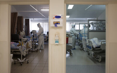 In this August 26, 2021 file photo, medical professionals treat patients in the coronavirus ward at Barzilai Medical Center in Ashkelon, Israel. (AP Photo/Maya Alleruzzo, File)