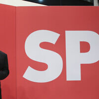 Olaf Scholz, Finance Minister and SPD candidate for Chancellor, waves during the election party at Willy Brandt House in Berlin, September 26, 2021. (Wolfgang Kumm/dpa via AP)