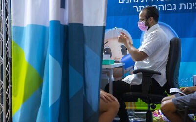 An Israeli receives the COVID-19 vaccine on September 20, 2021 in Jerusalem (Olivier Fitoussi/Flash90)