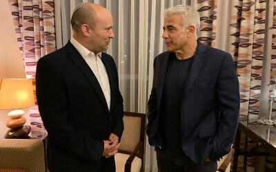 Yamina chief Naftali Bennett and Yesh Atid leader Yair Lapid are seen on Wednesday evening, as they inform President Reuven Rivlin they have succeeded in forming a government, June 2, 2021. (Courtesy)