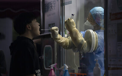 A man gets swapped during a nuclei test for COVID-19 in Beijing Sept. 18, 2021 (AP Photo/Ng Han Guan)