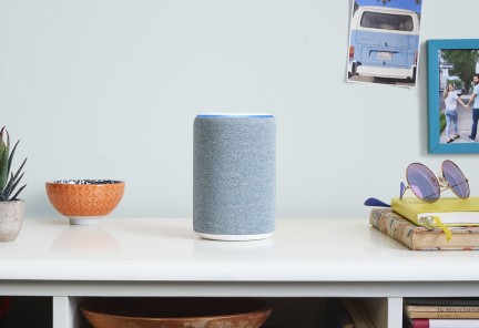 Alexa device sat on top of white desk 