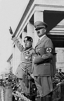 Mussolini and Hitler saluting troops