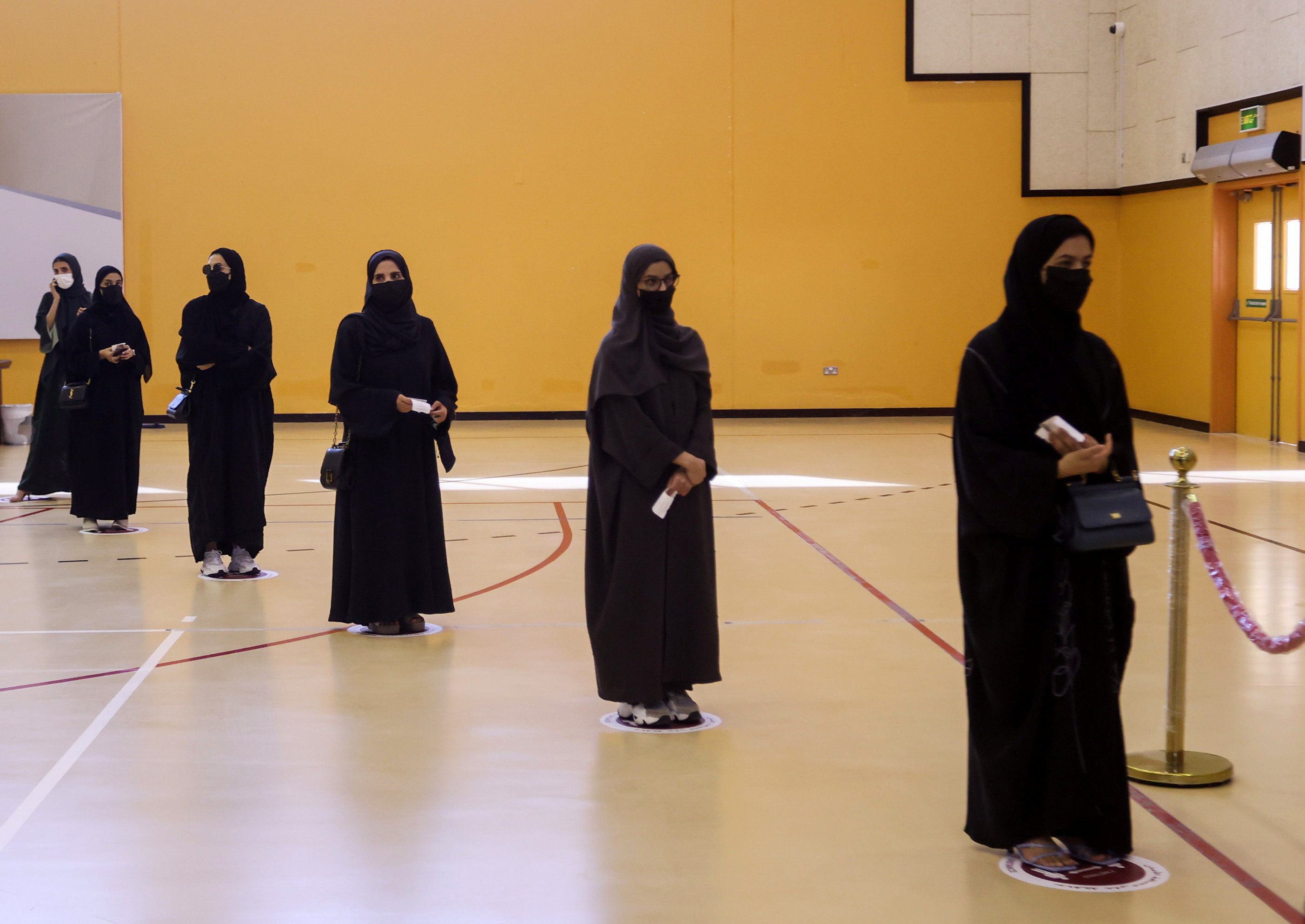 Voters line up at a polling station in the Gulf Arab state's first legislative elections for two-thirds of the advisory Shura Council, in Doha, Qatar October 2, 2021. REUTERS/Ibraheem Al Omari   