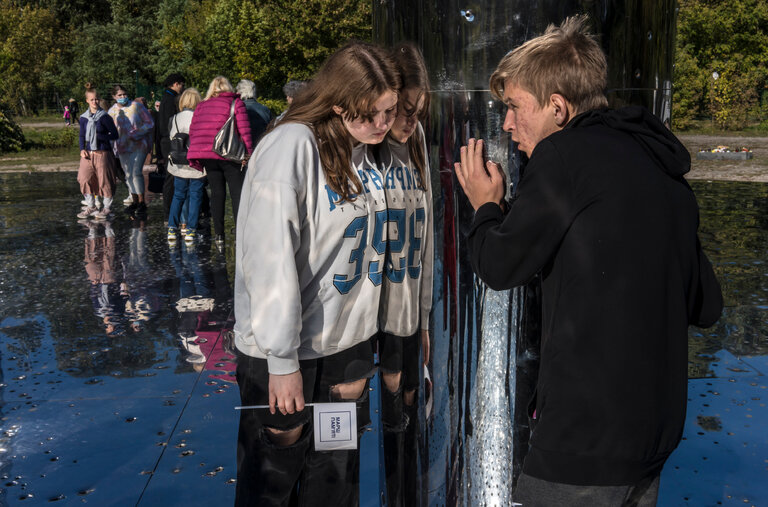 Visitors listening to the audio portion of the Mirror Field memorial at the Babyn Yar Holocaust Memorial Site in Ukraine on Sunday.