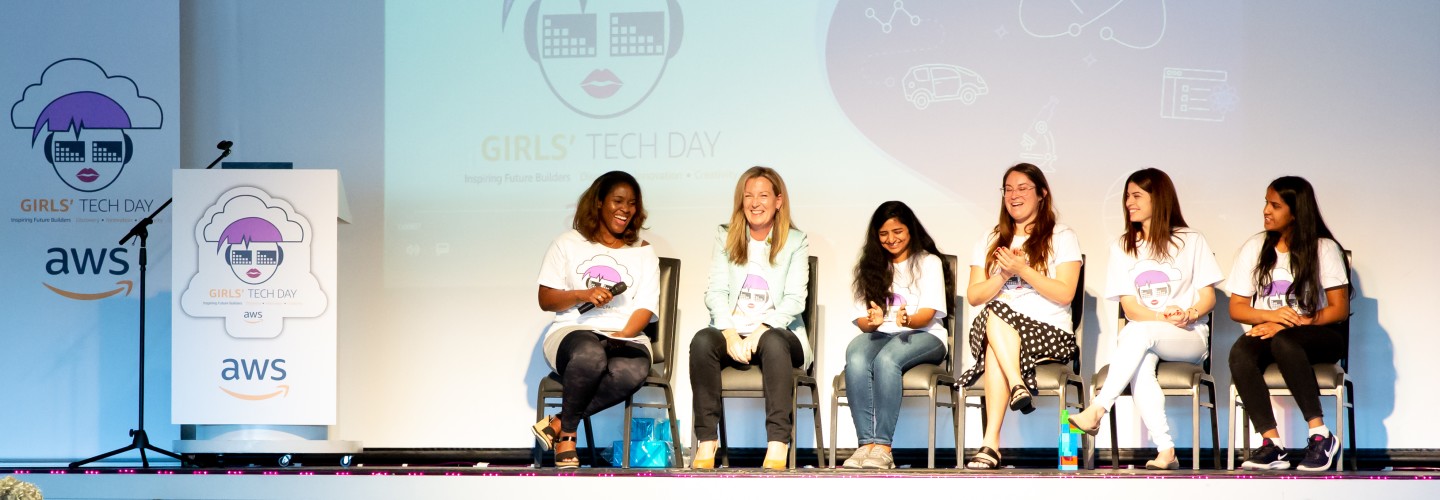 AWS InCommunities - Participating ladies and representatives of AWS, among them Cornelia Robinson, Global Leader of AWS InCommunity sit on stage and talk during an AWS InCommunity event