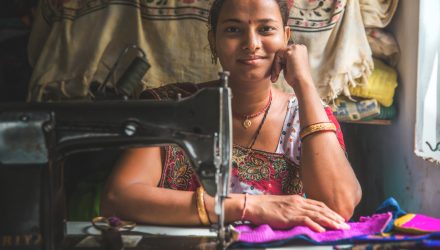 Bhavna Ben Ramesh in front of her sewing machine