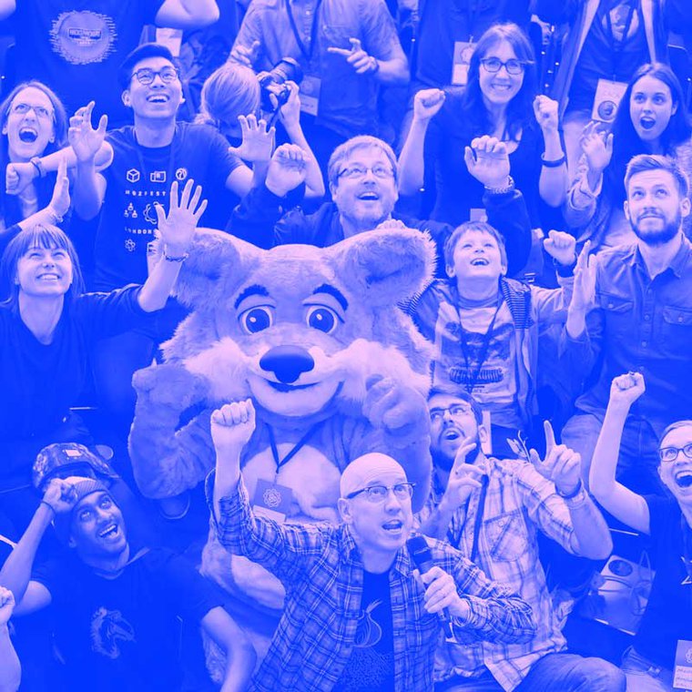 Group of people cheering at MozFest opening circle stage