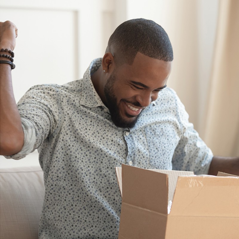 A collage of three images showing amazon boxes, and customers ordering online and opening boxes.