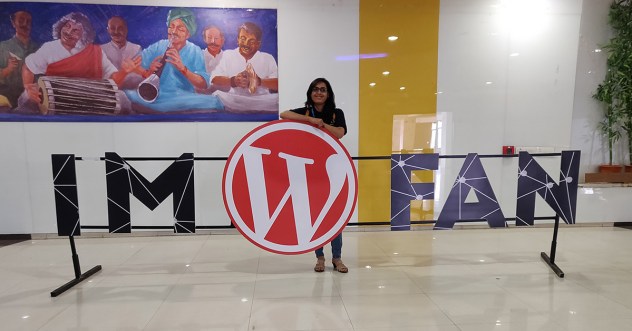 Pooja standing in a banner "I'm a WordPress fan"