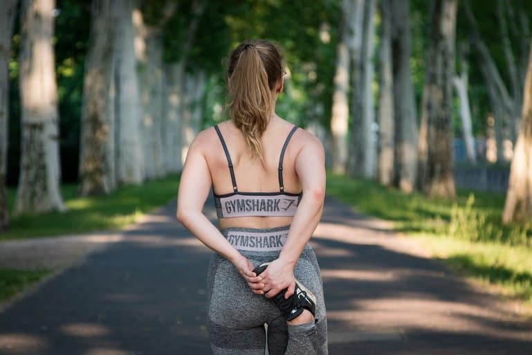 This shows a woman warming up for a run