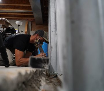 Crew installing full basement solution