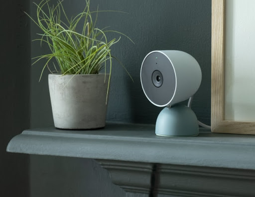 Nest Cam (wired) sits on a shelf inside a home.