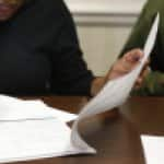 Home buyer signing paperwork at closing. (Photo by Photo by Ray Black III)