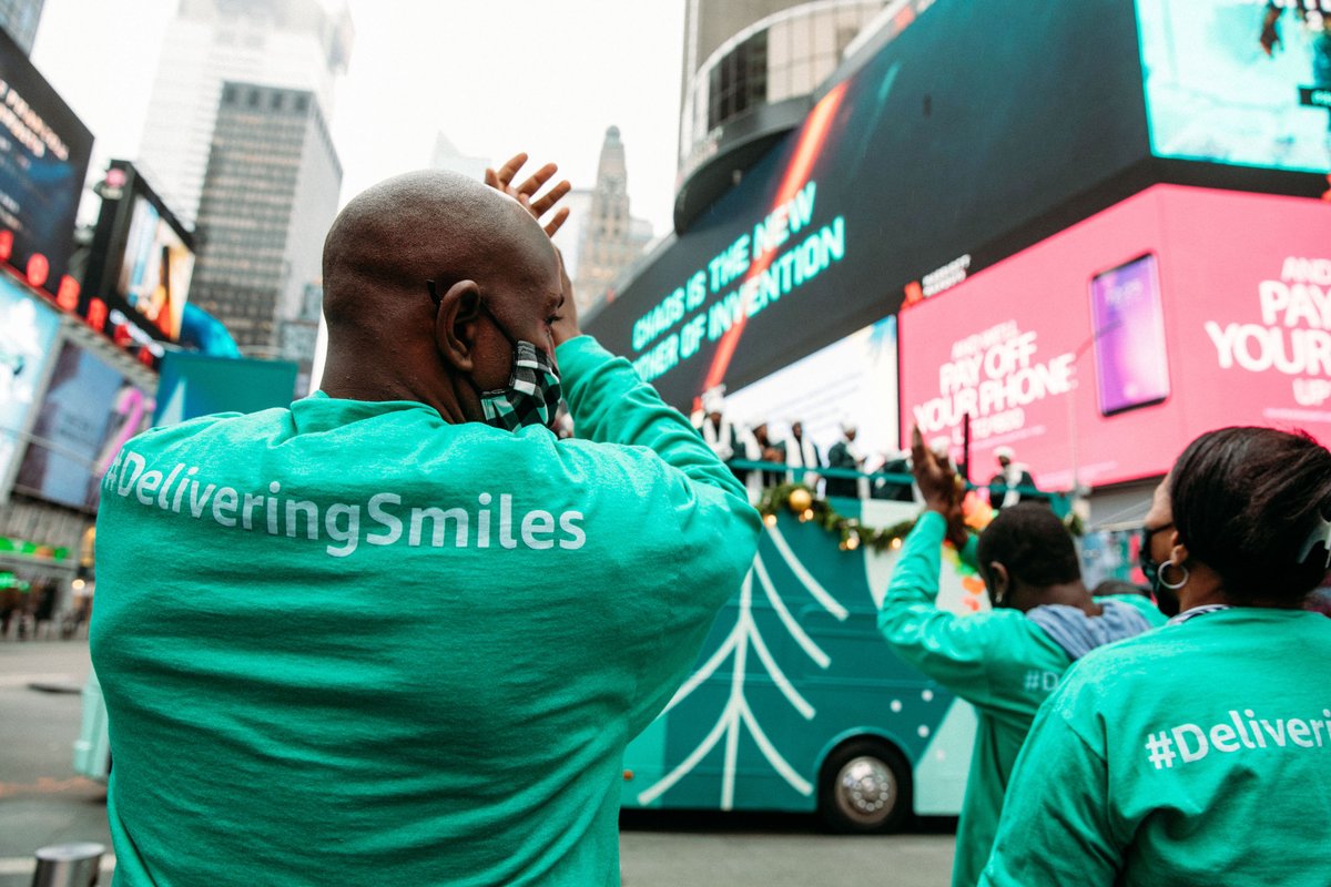 Amazon employee, Norman, dances while watching the choir at Times Square. 